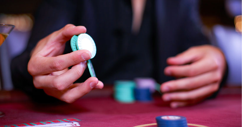 Blackjack Player Plaing With Chips